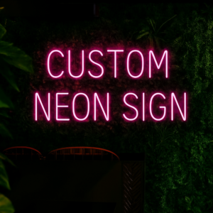 Custom LED neon sign with personalized text in pink script font mounted on wall